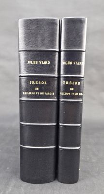 two black books sitting on top of each other on a table