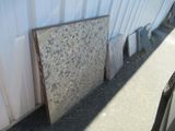 a pile of granite on the ground next to a building