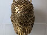 an image of a gold owl figurine sitting on top of a clear box