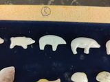a display case with a variety of animal figurines in it