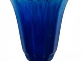 a blue glass vase sitting on top of a metal stand