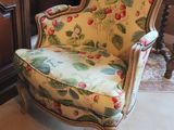 a chair that is sitting in a room with a rug on the floor