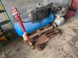 a blue air compressor sitting on a pallet next to a red fire hydrant