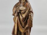 a statue of a man in a robe holding a book