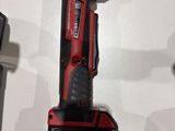 the cordless drill is sitting on the table next to the other tools
