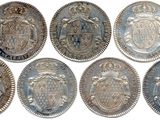 six different types of silver coins are shown on a white background