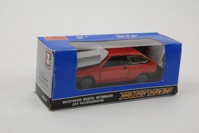 boxed red toy car in a blue box on a white surface