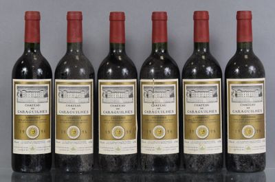 six bottles of wine are lined up in a row on a table