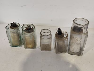 cinq bocaux en verre alignés sur une table