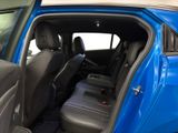 the interior of a blue car with the door open and the passenger seat down