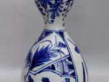 a blue and white vase with a bird on it