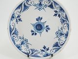 a blue and white plate with a flower design on it