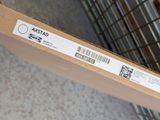 a box with a sticker on it sitting on a carton