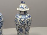 two blue and white vases sitting on a table