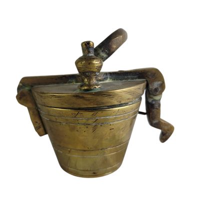 antique brass ice bucket with a wooden handle on a white background