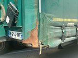 a green truck that is parked on the side of the road