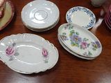many plates and bowls on a table with a teapot