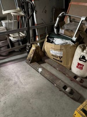a forklift in a garage with a lot of tools