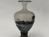 vase with a black and white scene of a boat on the water