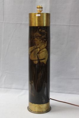 a black and gold lamp with a picture of a woman on it