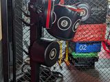 a cage with a bunch of boxing gloves on top of it