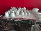 a coffee machine that has cups on top of it
