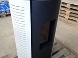 a black and white stove sitting on a pallet in a warehouse
