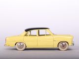 yellow toy car with a surfboard on top of the roof