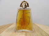 a bottle of perfume sitting on a wooden table