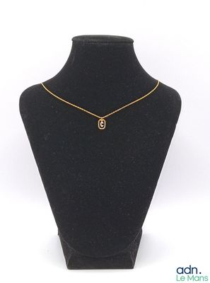 un mannequin noir portant un collier en or