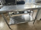 a stainless steel table in a kitchen with pots and pans on it