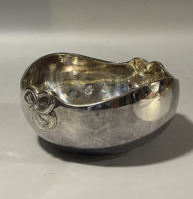 a silver bowl that is sitting on a table