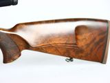 a close up of a rifle on a white background with a gun in the foreground