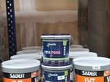 many cans of paint on a shelf in a store