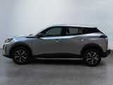 a silver suv parked in a room with a white wall
