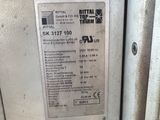 a metal sign on the side of a machine