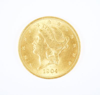 Gros plan sur une pièce d'or ornée d'une tête de femme