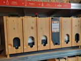 many wooden boxes that are on a shelf in a store