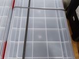 two plastic storage boxes sitting on a wooden table