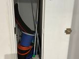 a small closet with a lot of cleaning supplies in it
