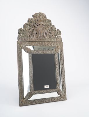 an antique silver mirror with ornate design on a white background