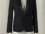 a mannequin wearing a black suit on a white mannequin