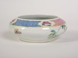 a white bowl with a blue and pink design on it