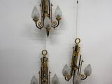 three wall sconces hanging on the wall next to each other