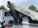 a white truck with a crane on the back of it