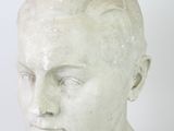 marble bust of a young boy with a short haircut