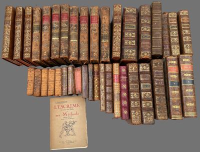 several old books stacked on top of each other on a table