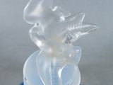 figurine of a glass angel on a blue base on a white background