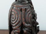a statue of a man riding an elephant on a wooden table