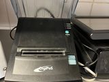 a printer sitting on top of a counter next to a printer